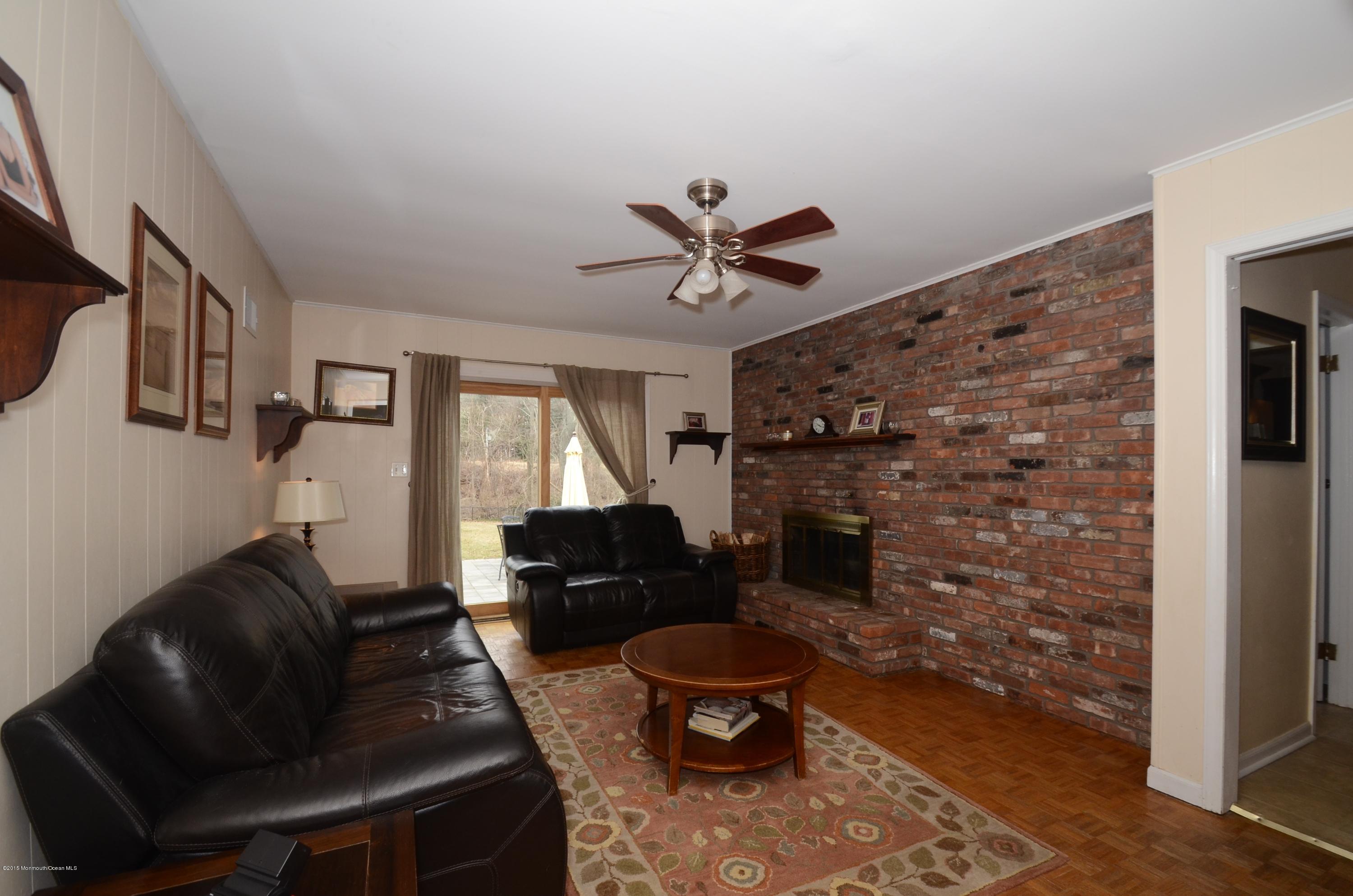 44 Farm Road Middletown, NJ 07748 - Photo 17 of 17 a living room with furniture and a fireplace