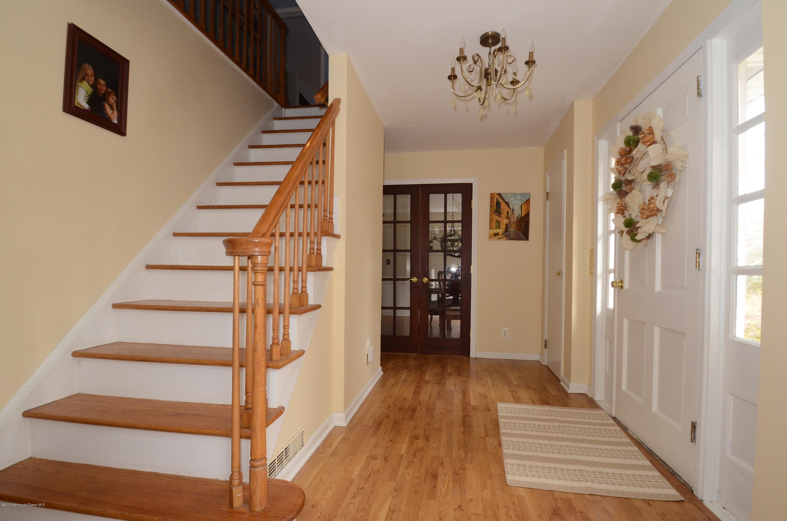 44 Farm Road Middletown, NJ 07748 - Photo 5 of 17 a view of entryway with stairs and wooden floor