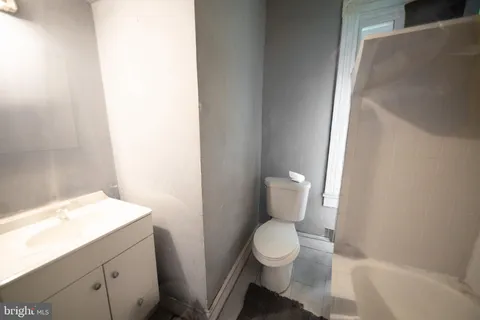 a white toilet sitting next to a white sink