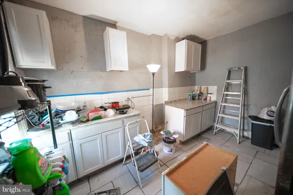 a room with furniture a rug toys and a window