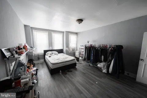 a living room with furniture a flat screen tv and a window