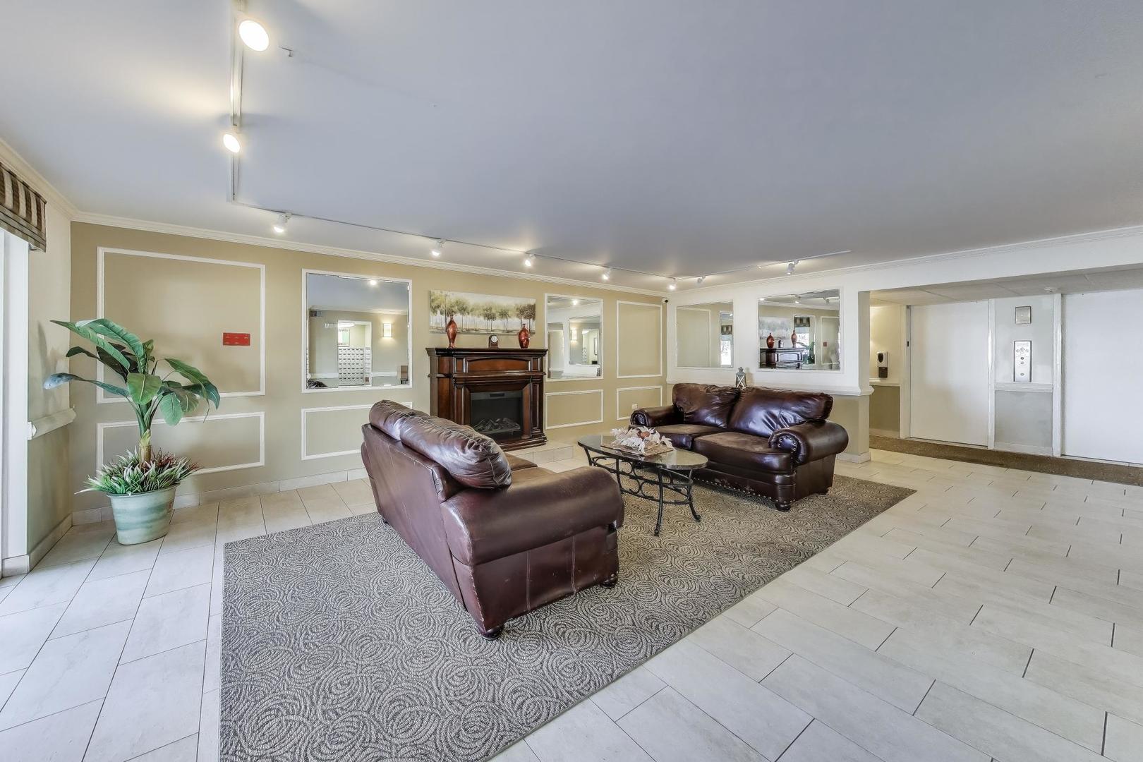 841 North York Street, Unit 109 Elmhurst, IL 60126 - Photo 15 of 34 a living room with furniture fireplace and potted plant