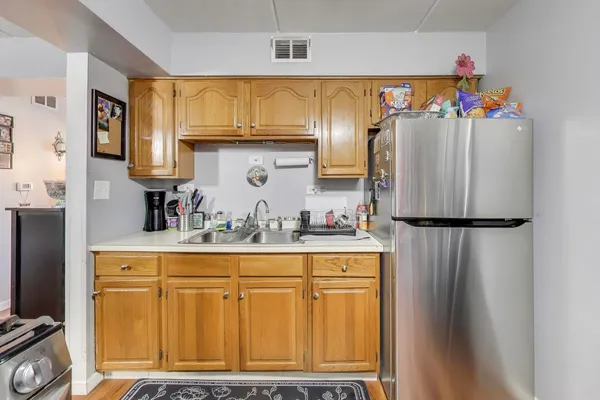 a kitchen with stainless steel appliances granite countertop a refrigerator and a stove
