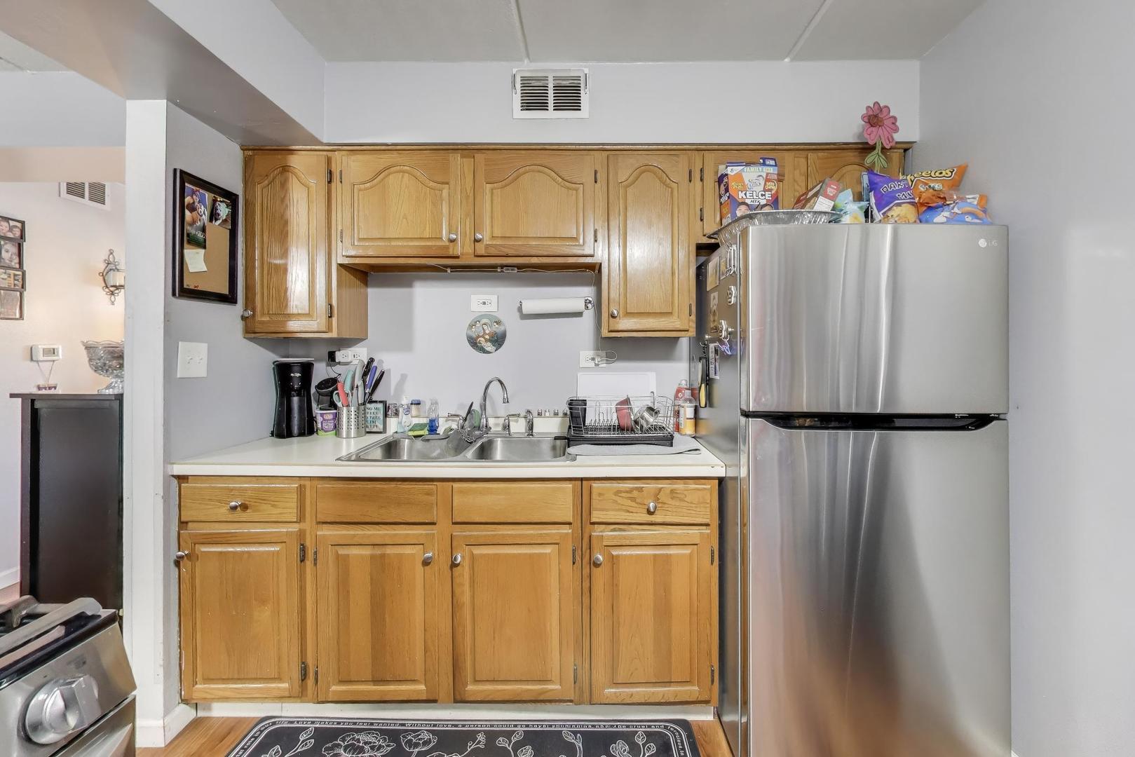 841 North York Street, Unit 109 Elmhurst, IL 60126 - Photo 5 of 34 a kitchen with stainless steel appliances granite countertop a refrigerator and a stove