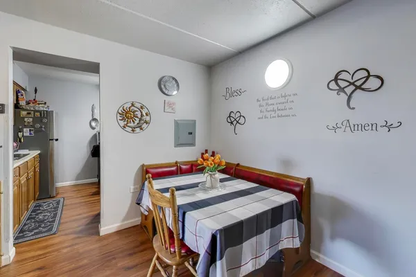 a view of a dining room with furniture and wooden floor