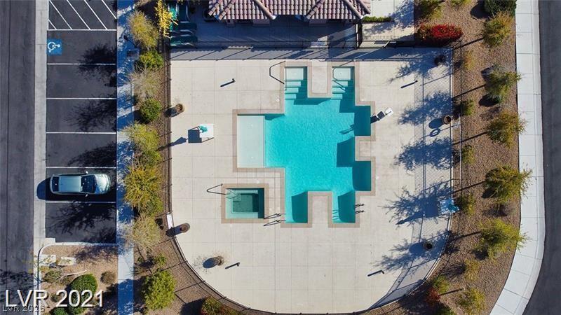 5475 Ordesa Valley Road Las Vegas, NV 89148 - Photo 5 of 35 An aerial perspective reveals a vibrant community pool area complete with a spa and ample parking.
