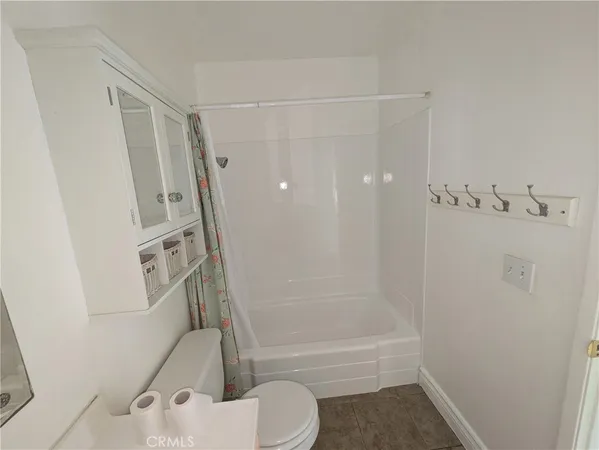 a bathroom with a shower and a toilet