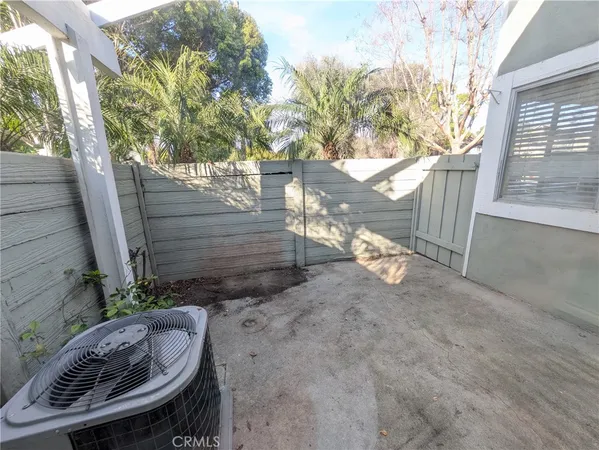 a view of a chair and table in backyard