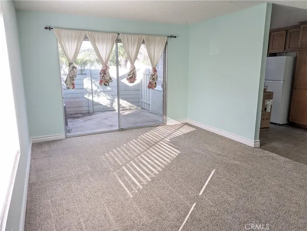 a bedroom with a bed and glass door