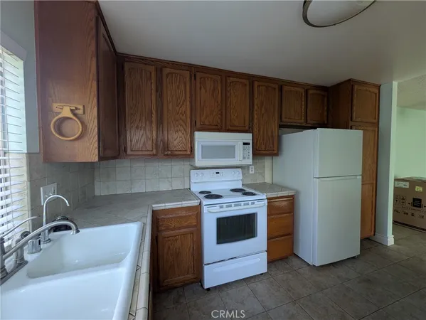 a kitchen with a refrigerator sink and stove