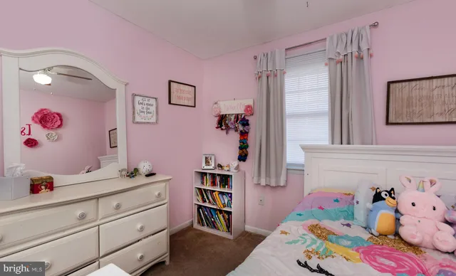 a bedroom with a bed and a book shelf
