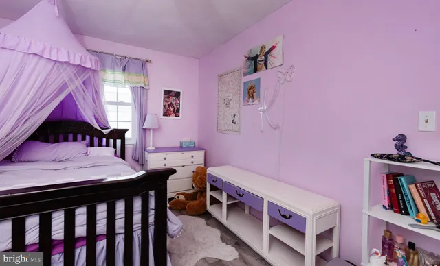 a bedroom with furniture and a book shelf