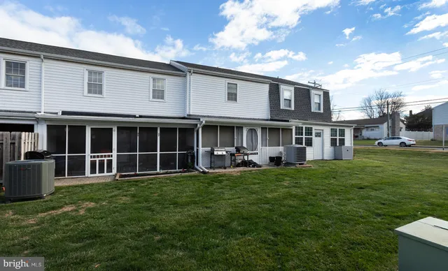 a view of a house with a yard and sitting area