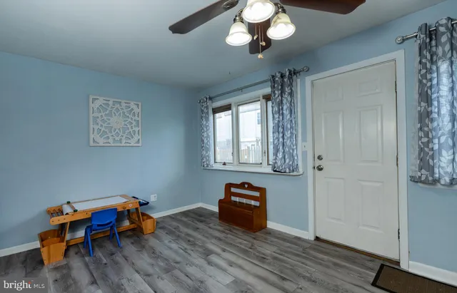 a bedroom with furniture and wooden floor