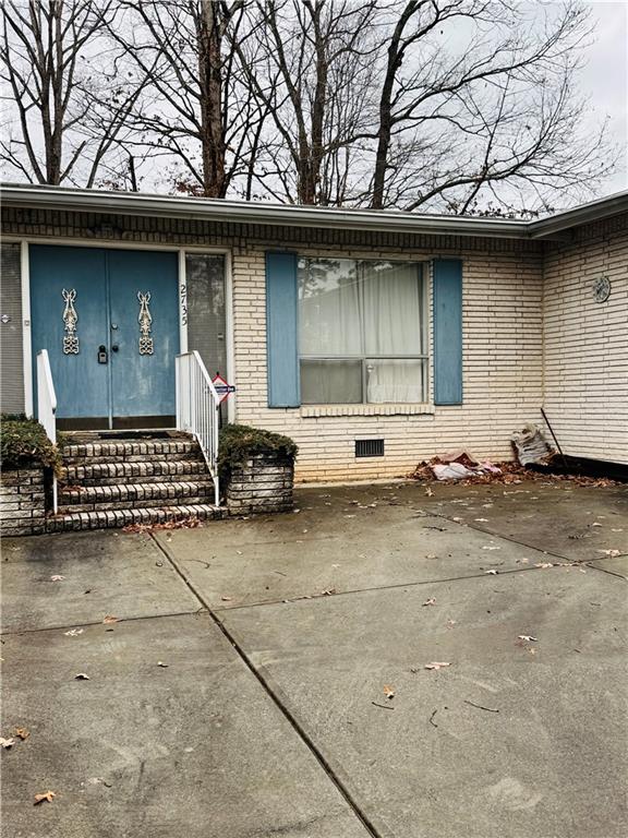 a front view of a house with parking space