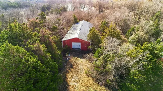 an aerial view of lake and residential houses with outdoor space