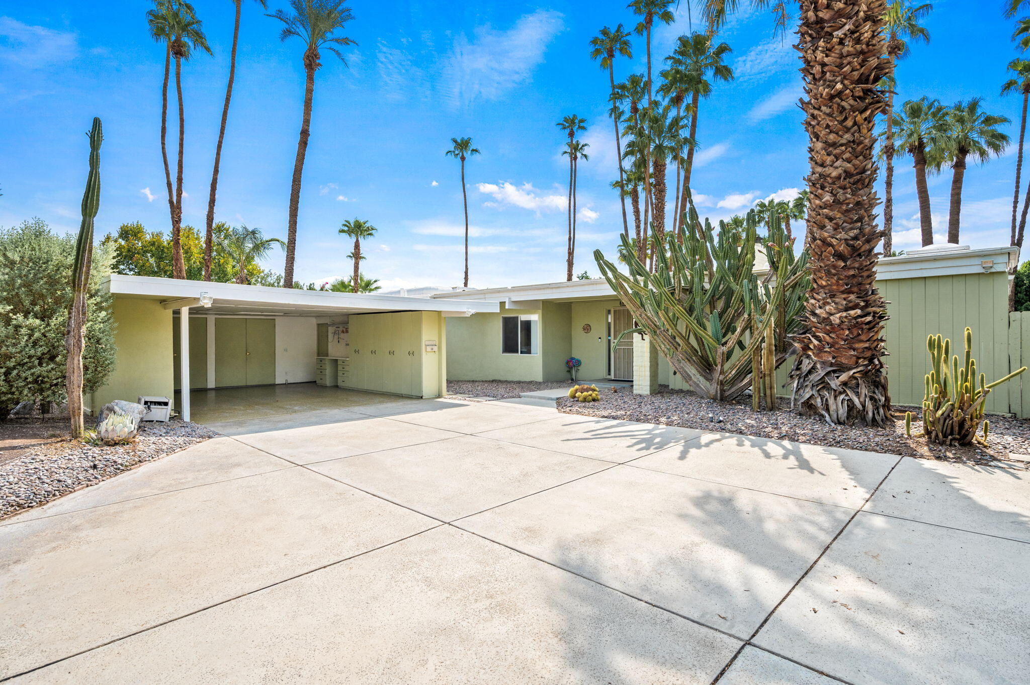 71888 Vista Del Rio Rancho Mirage, CA 92270 - Photo 2 of 36 a view of a house with a yard and potted plants