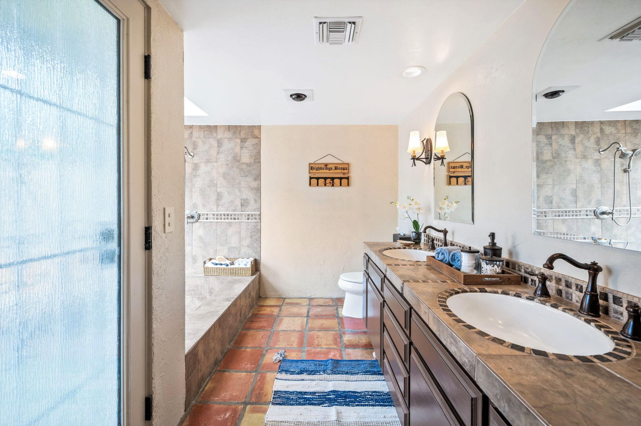 71888 Vista Del Rio Rancho Mirage, CA 92270 - Photo 12 of 36 a bathroom with a double vanity sink a mirror and a shower