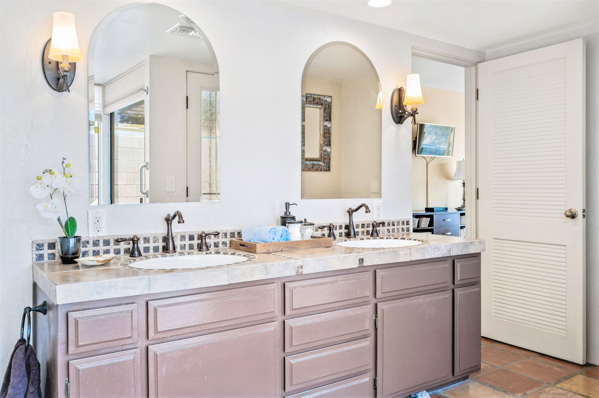 71888 Vista Del Rio Rancho Mirage, CA 92270 - Photo 14 of 36 a bathroom with a double vanity sink and mirror