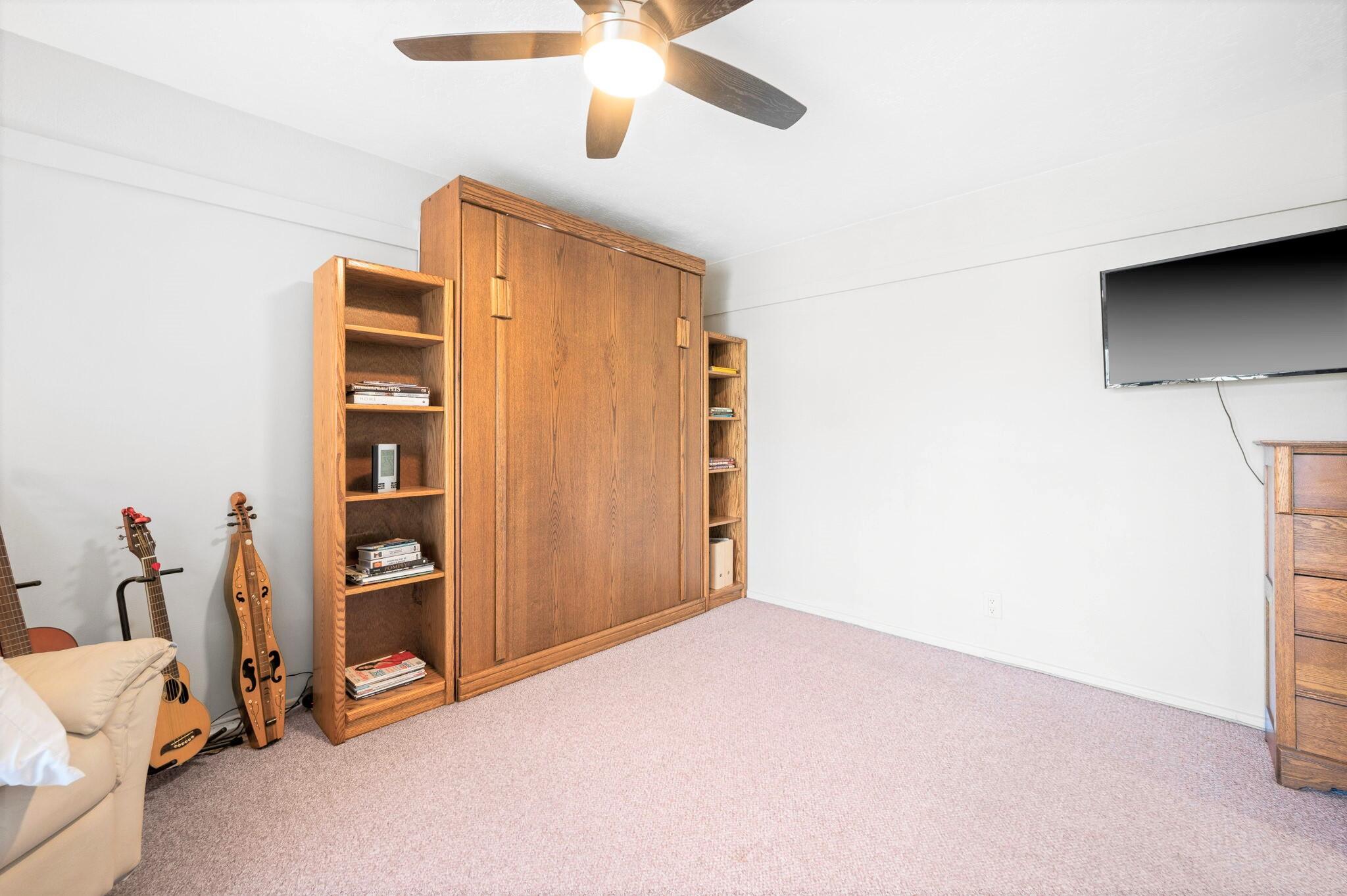 71888 Vista Del Rio Rancho Mirage, CA 92270 - Photo 17 of 36 a view of a bedroom with closet and a ceiling fan