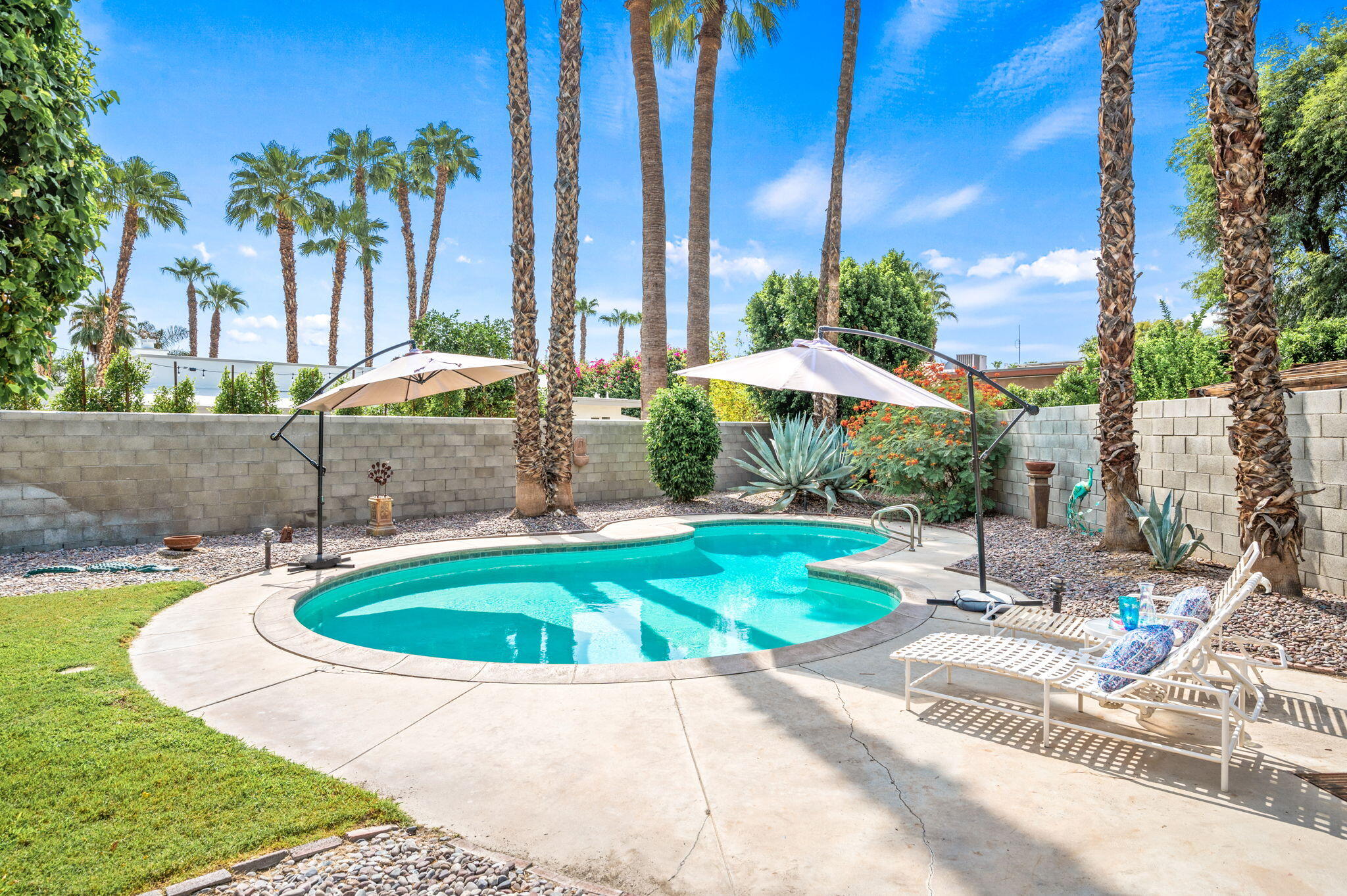 71888 Vista Del Rio Rancho Mirage, CA 92270 - Photo 23 of 36 a view of a swimming pool with a patio