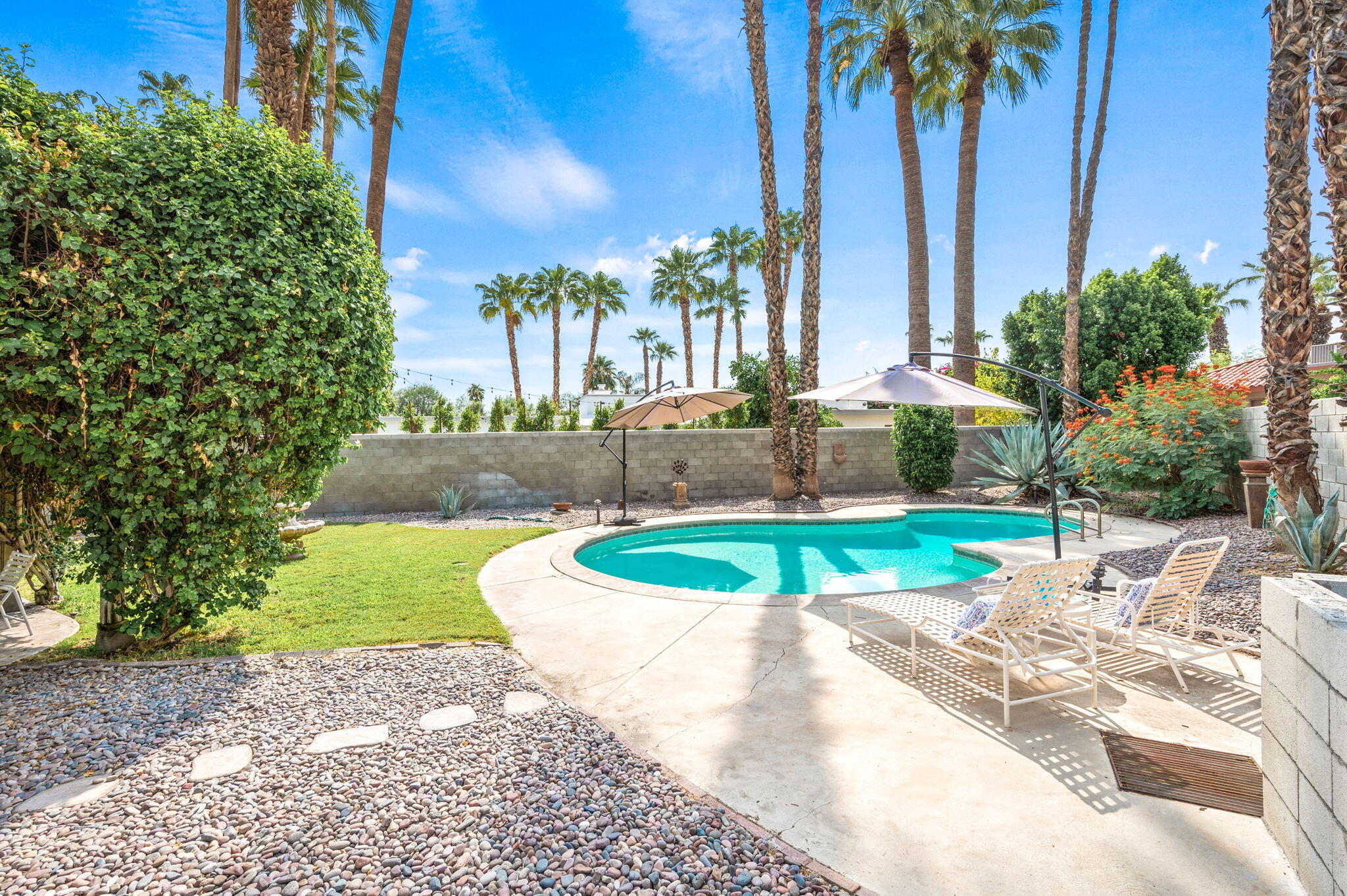 71888 Vista Del Rio Rancho Mirage, CA 92270 - Photo 24 of 36 a swimming pool with outdoor seating and yard