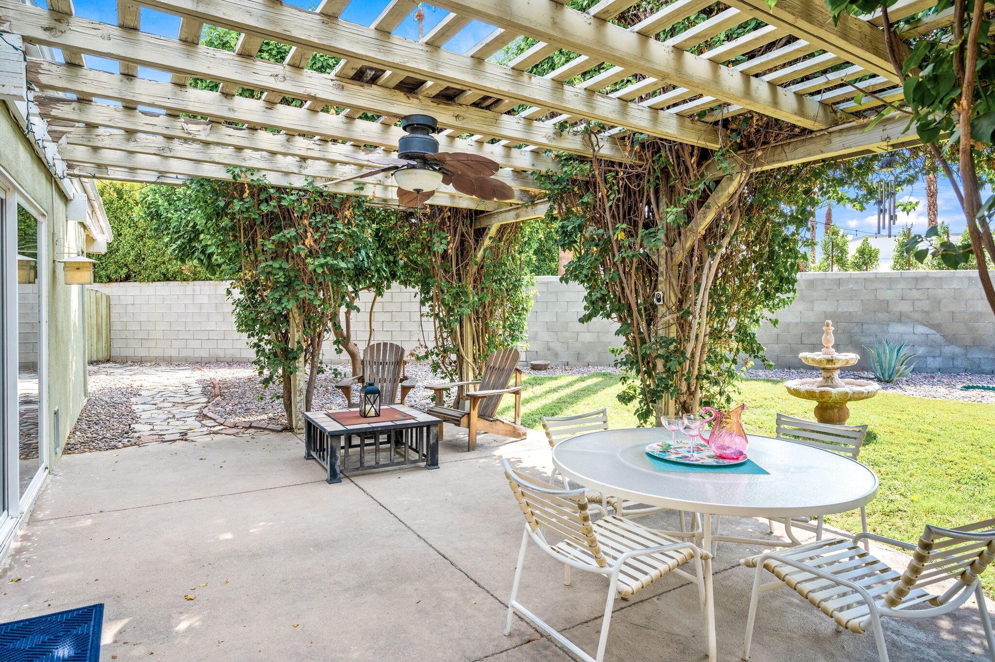71888 Vista Del Rio Rancho Mirage, CA 92270 - Photo 25 of 36 a backyard of a house with a table and chairs