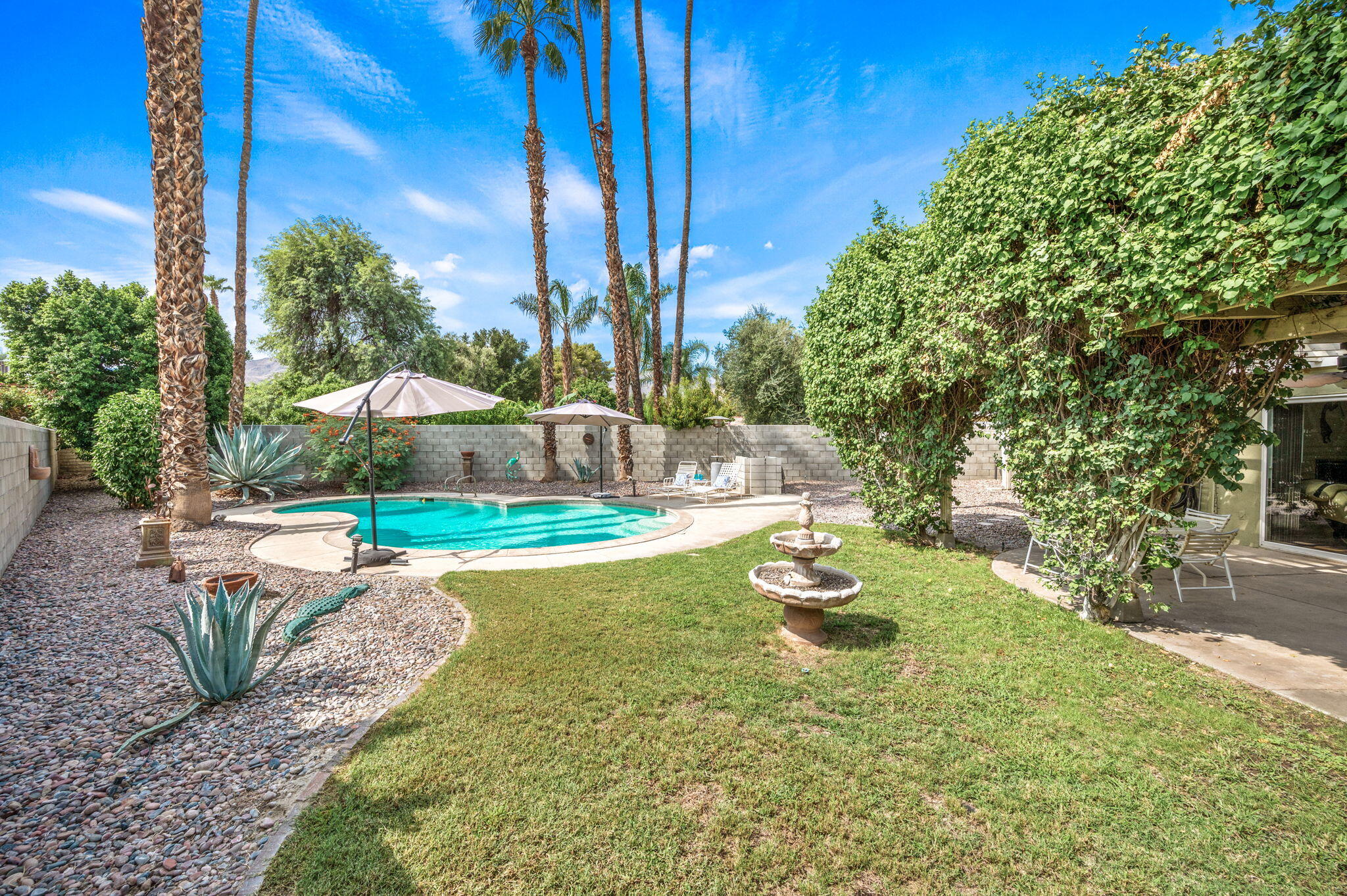 71888 Vista Del Rio Rancho Mirage, CA 92270 - Photo 26 of 36 a view of a swimming pool with a patio