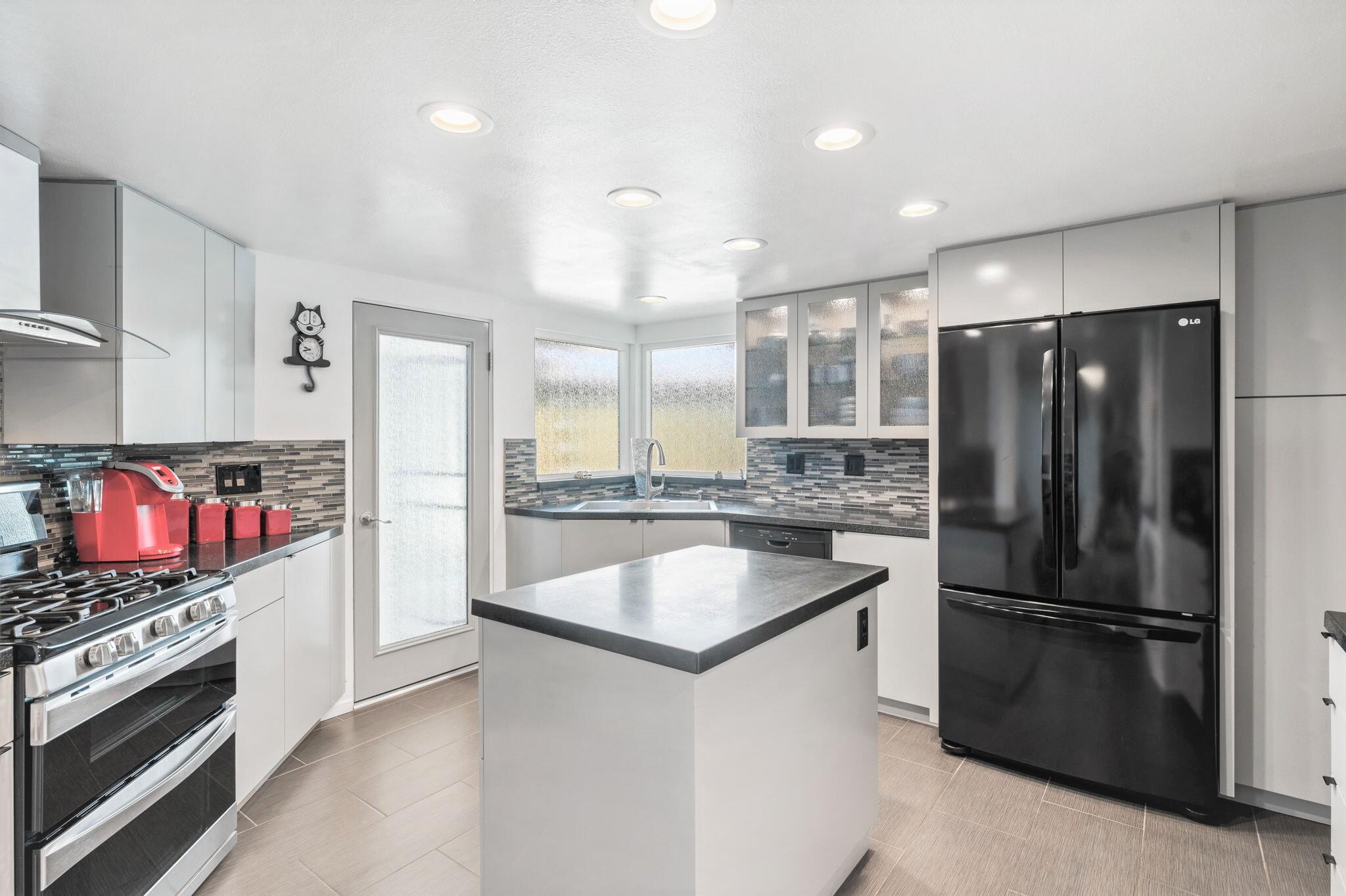 71888 Vista Del Rio Rancho Mirage, CA 92270 - Photo 4 of 36 a kitchen with stainless steel appliances granite countertop a refrigerator a stove and a sink