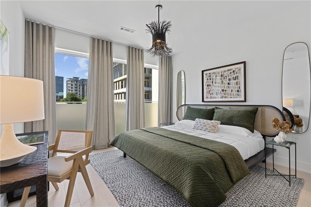 775 Juniper Street Northeast, Unit 404 Atlanta, GA 30308 - Photo 9 of 22 a spacious bedroom with a bed dresser and a window