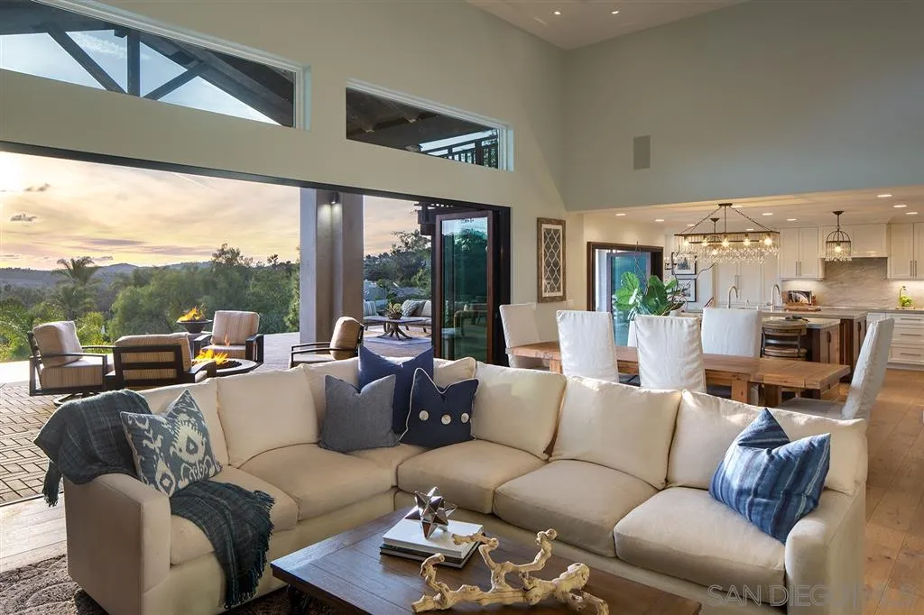 a living room with furniture wooden floor and a large window