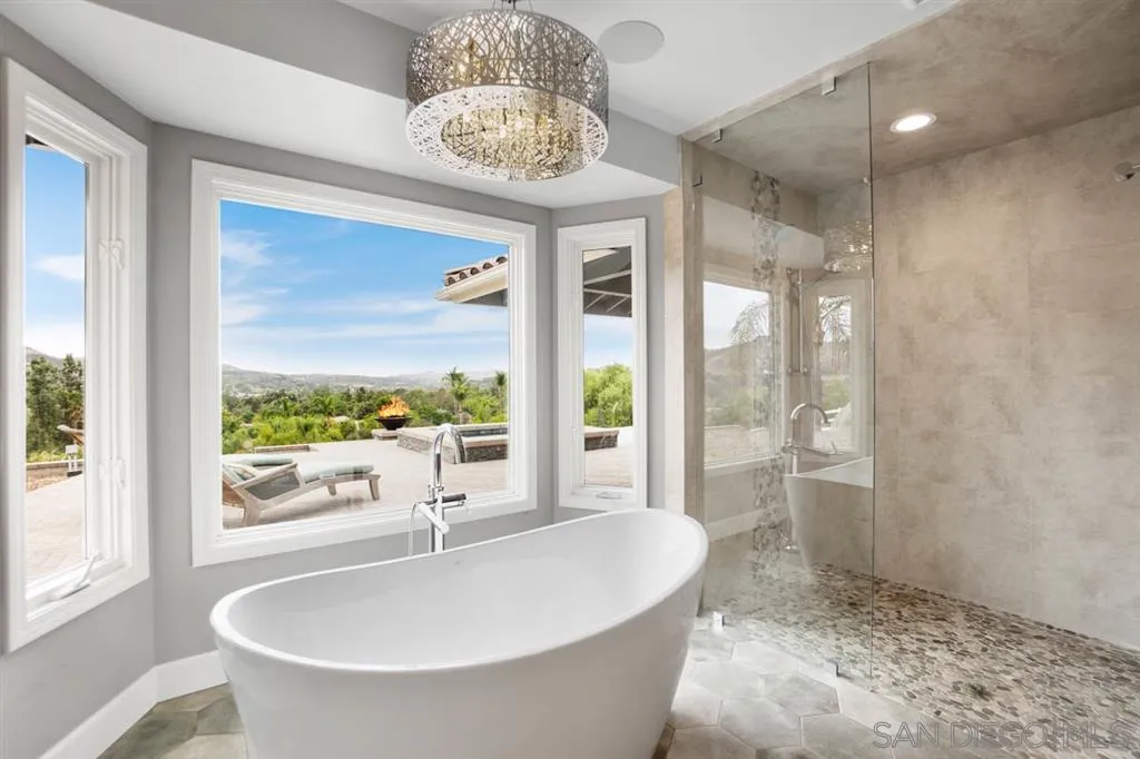 7190 Vía Mariposa Norte Bonsall, CA 92003 - Photo 13 of 25 a spacious bathroom with a bathtub and shower