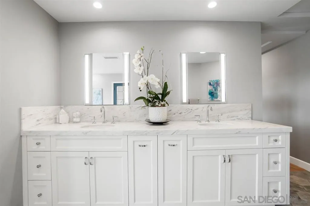 7190 Vía Mariposa Norte Bonsall, CA 92003 - Photo 14 of 25 a bathroom with a sink a vanity and a mirror