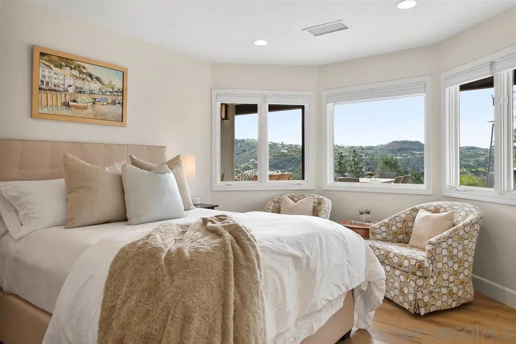 7190 Vía Mariposa Norte Bonsall, CA 92003 - Photo 15 of 25 a bedroom with a bed and a large window