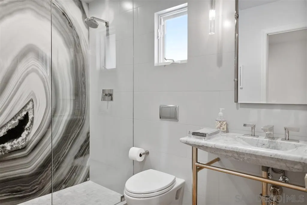 7190 Vía Mariposa Norte Bonsall, CA 92003 - Photo 16 of 25 a bathroom with a sink a toilet and shower