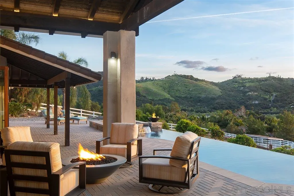 7190 Vía Mariposa Norte Bonsall, CA 92003 - Photo 2 of 25 an outdoor living room with patio furniture and a garden