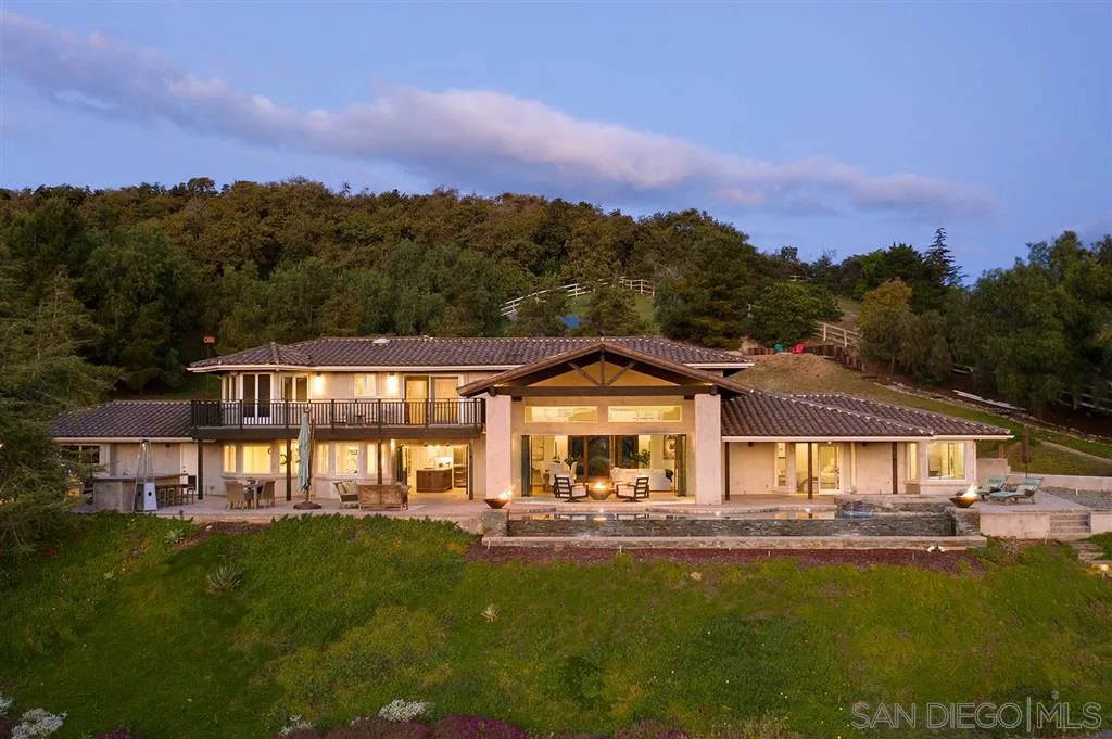 7190 Vía Mariposa Norte Bonsall, CA 92003 - Photo 3 of 25 a front view of a house with a garden