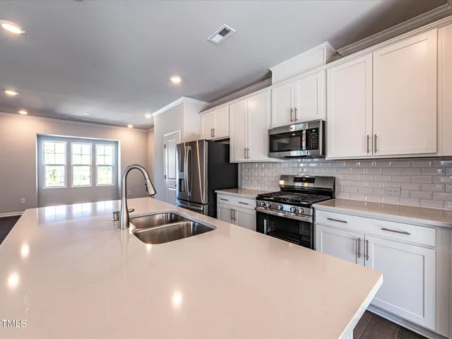 a view of kitchen with wooden floor electronic appliances and window