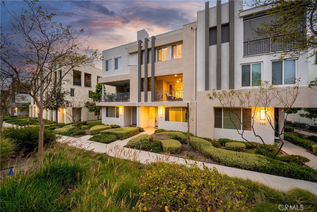 a front view of a residential apartment building with a yard