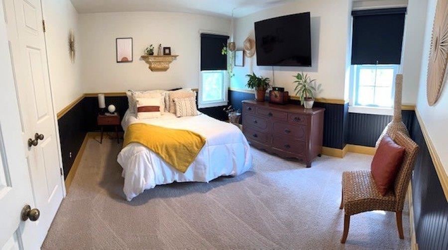 1897 Corbin Road Germantown, TN 38139 - Photo 14 of 22 Carpeted room featuring wainscoting with a dark finish and light trim, two windows with dark roller shades, and a ceiling-mounted light fixture