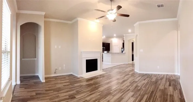 a view of a kitchen with a ceiling fan wooden floor and a kitchen