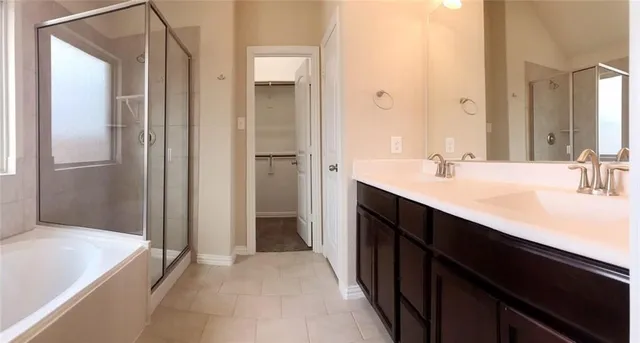 a bathroom with a double vanity sink and mirror