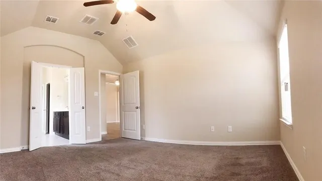 an empty room with fan and entrance