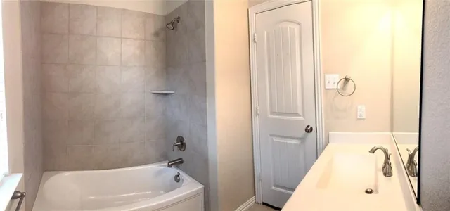 a bathroom with a tub and shower