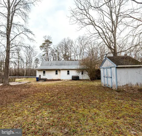 a view of a house with a yard covered in snow