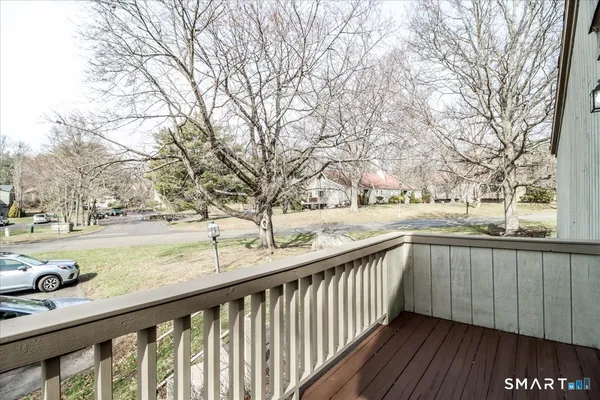 a view of balcony with wooden floor and fence