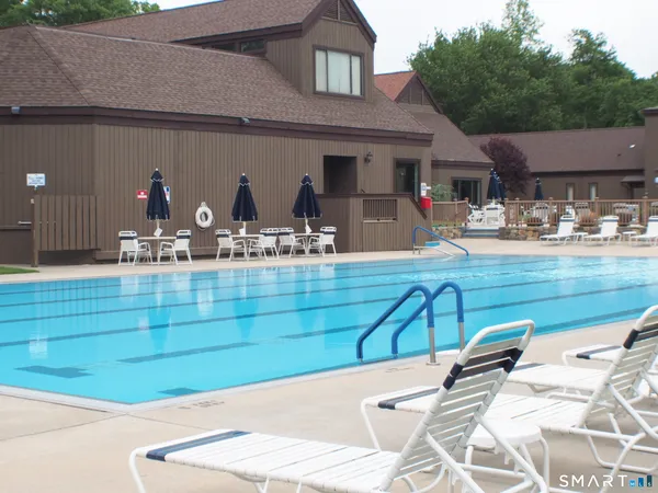 a front view of a house with garden and sitting area