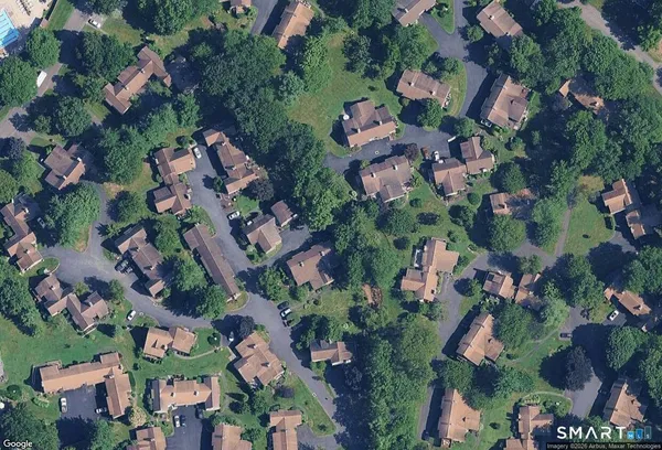 a view of a sign board with buildings in the background