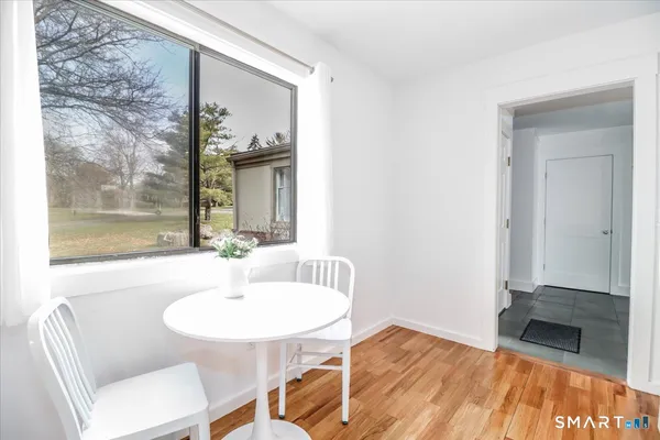 a view of a dining room with furniture and wooden floor