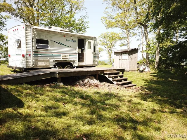 a view of yard with large trees